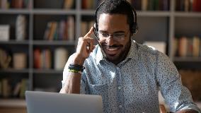 man on laptop with headset